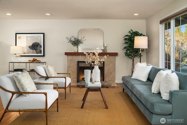 sitting room with a tiled fireplace and recessed lighting