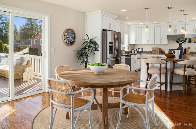 dining area with recessed lighting and light wood-type flooring