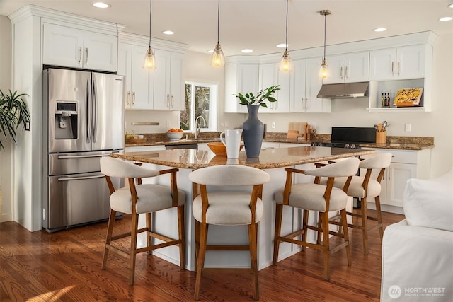 kitchen featuring under cabinet range hood, dark wood finished floors, stainless steel refrigerator with ice dispenser, and white cabinetry