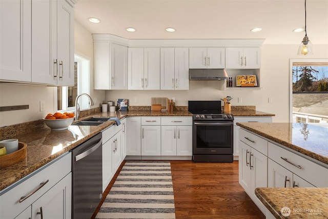 kitchen featuring dark wood-style flooring, a sink, under cabinet range hood, appliances with stainless steel finishes, and white cabinetry