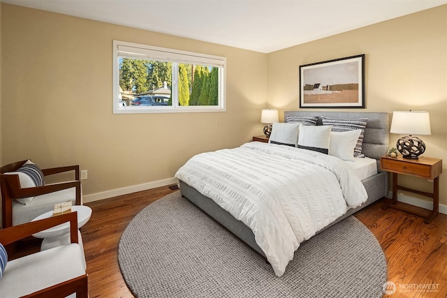 bedroom with wood finished floors and baseboards