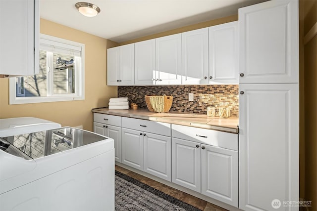 laundry area with washer and clothes dryer and cabinet space