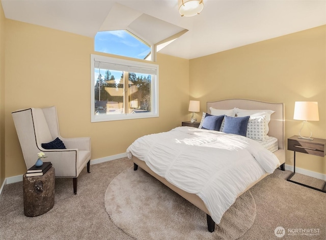 carpeted bedroom with baseboards and vaulted ceiling