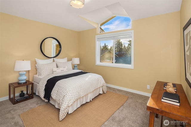 carpeted bedroom with baseboards and vaulted ceiling