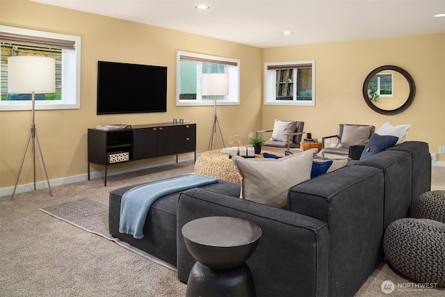 carpeted living area with recessed lighting and baseboards