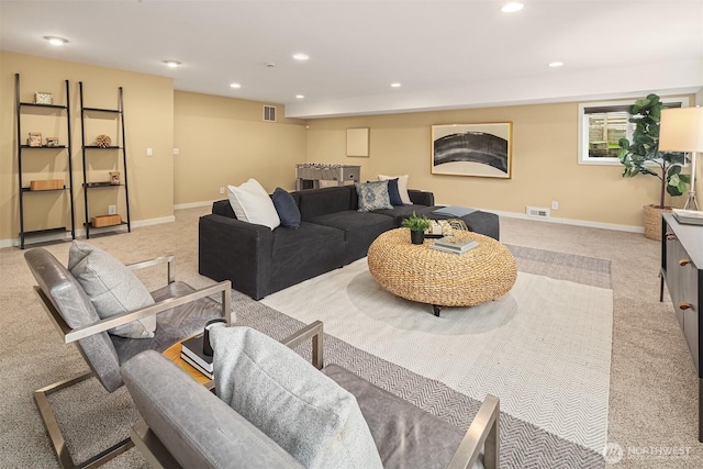 living area featuring recessed lighting, visible vents, and baseboards