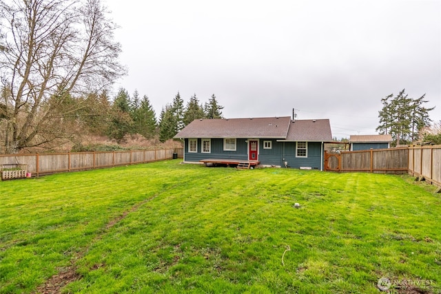 back of house featuring crawl space, a yard, roof with shingles, and a fenced backyard