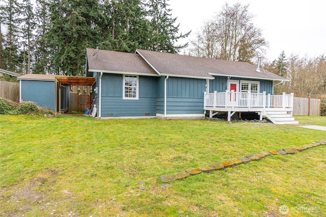 ranch-style home with a front yard, fence, crawl space, a deck, and board and batten siding