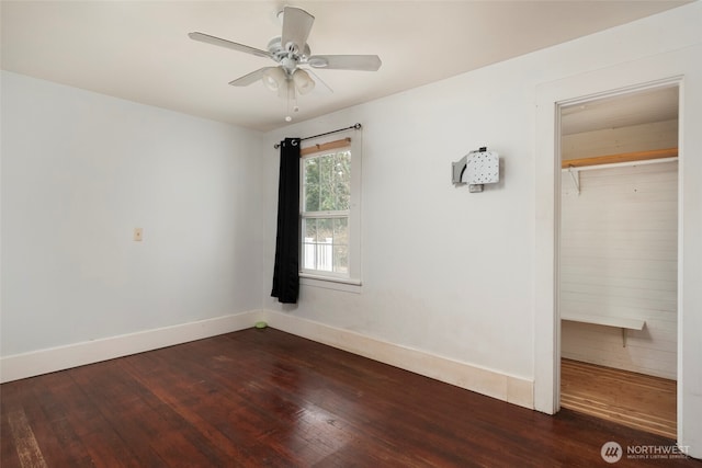 unfurnished bedroom featuring baseboards, wood-type flooring, and a ceiling fan