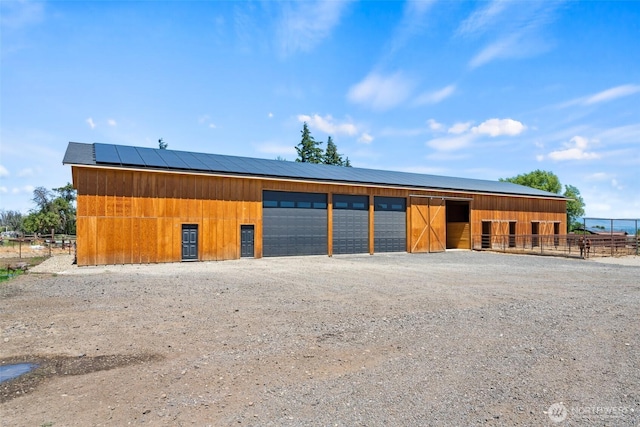 detached garage featuring dirt driveway