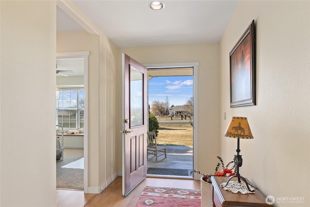 entryway featuring baseboards and light wood-style floors