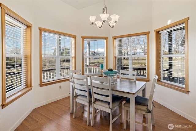 dining area with light wood-style flooring, a healthy amount of sunlight, and baseboards