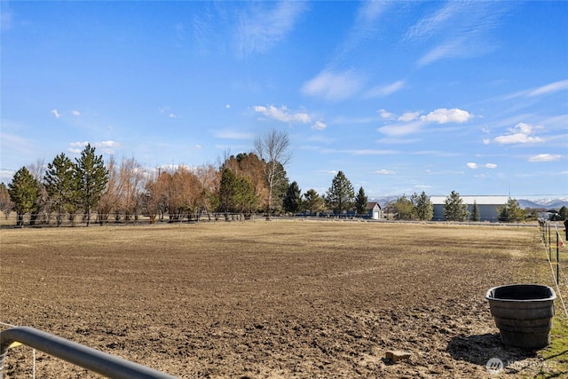 view of yard featuring a rural view and fence