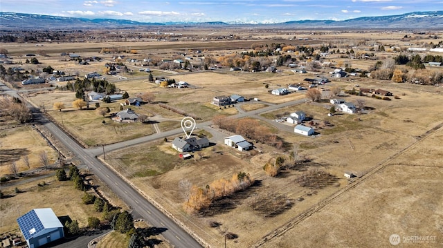 drone / aerial view featuring a desert view, a rural view, and a mountain view