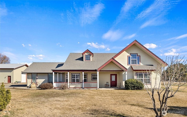 view of front of house featuring covered porch and a front lawn