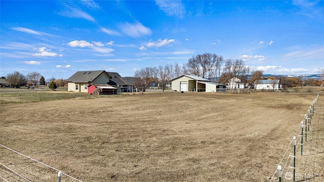 view of yard featuring a rural view and fence