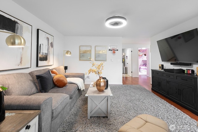 living room featuring baseboards and dark wood-style flooring