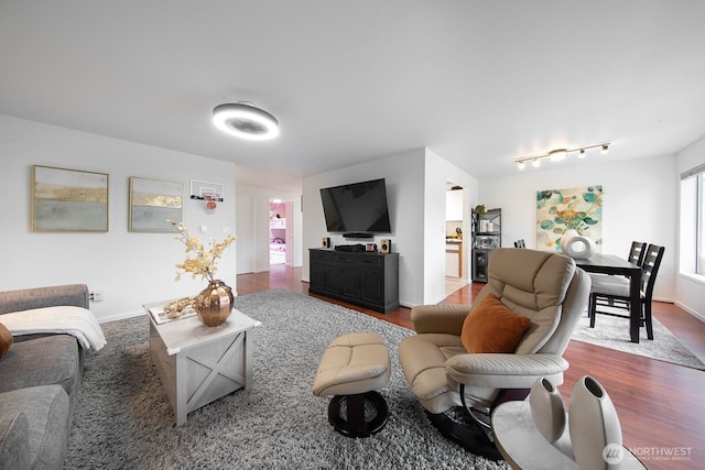 living room featuring baseboards and wood finished floors