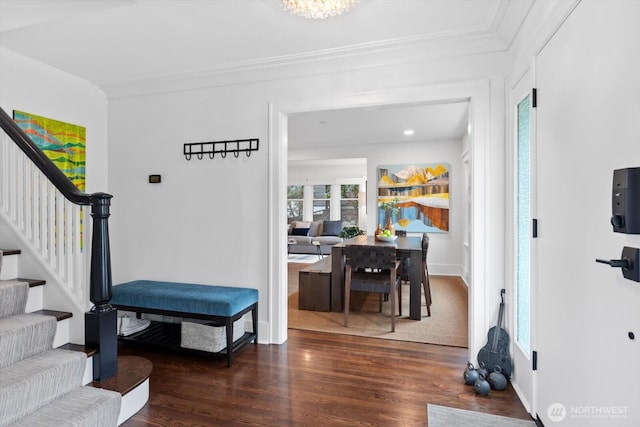 foyer entrance featuring stairway, baseboards, wood finished floors, and crown molding