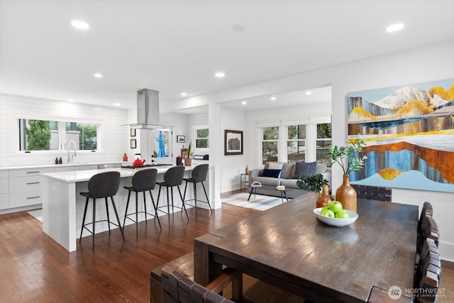 dining area featuring plenty of natural light, recessed lighting, and dark wood-style flooring