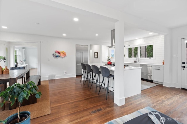 kitchen featuring visible vents, light countertops, and dark wood-type flooring