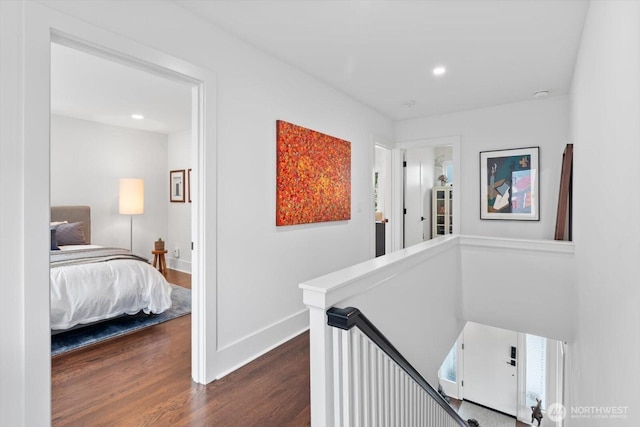 corridor featuring an upstairs landing, recessed lighting, dark wood finished floors, and baseboards