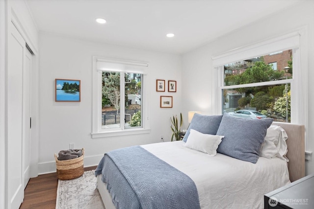 bedroom featuring recessed lighting, multiple windows, baseboards, and wood finished floors