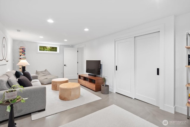 living room with recessed lighting, visible vents, and concrete floors