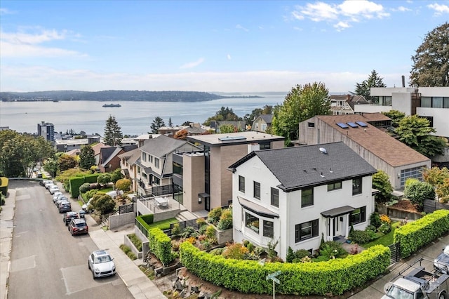 drone / aerial view featuring a residential view and a water view