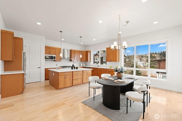 interior space featuring recessed lighting, light wood-style flooring, and an inviting chandelier