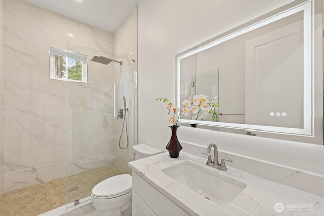 full bathroom with vanity, toilet, and a marble finish shower