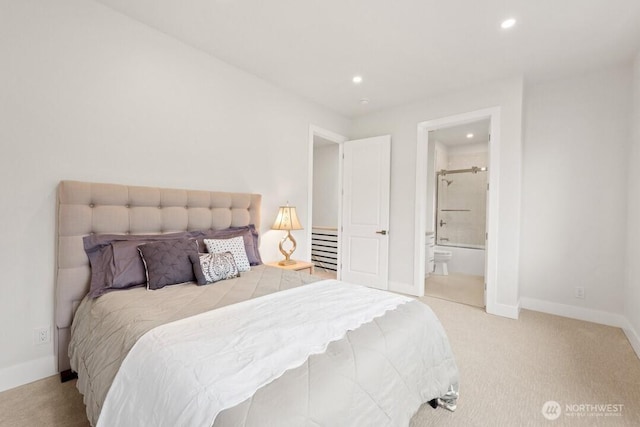 carpeted bedroom featuring recessed lighting, baseboards, and ensuite bathroom