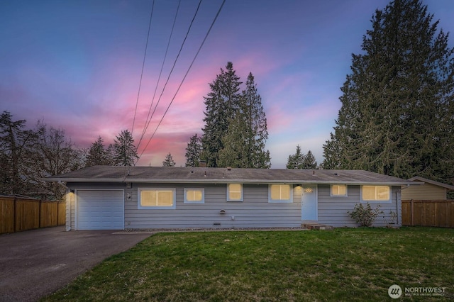 single story home with a garage, a lawn, driveway, and fence