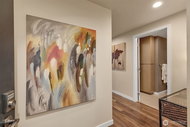 hallway with recessed lighting, baseboards, and wood finished floors