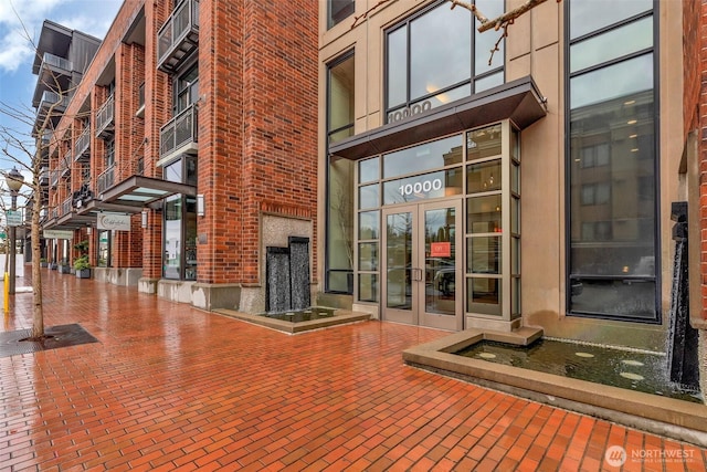 exterior space with brick floor and a fireplace