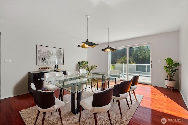 dining space with wood finished floors