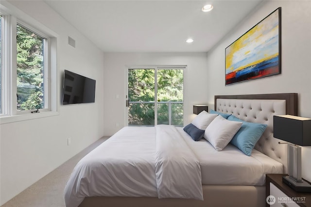 carpeted bedroom featuring multiple windows, recessed lighting, and visible vents