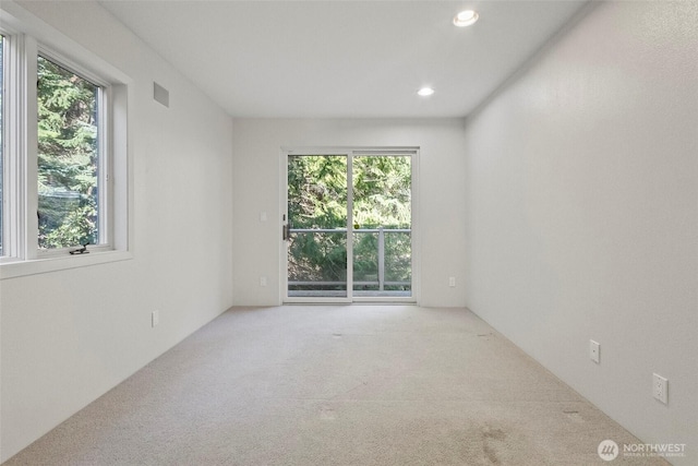 carpeted empty room with recessed lighting and visible vents