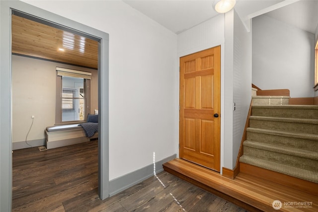 entrance foyer with stairway, baseboards, and dark wood-style flooring