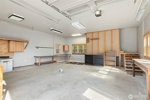 garage with a workshop area and a garage door opener