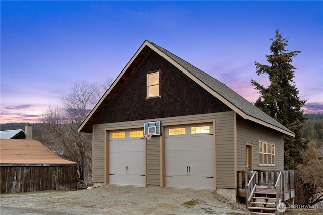 garage at dusk featuring a garage
