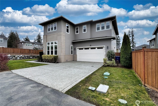 view of front of house with brick siding, a garage, concrete driveway, and a front yard