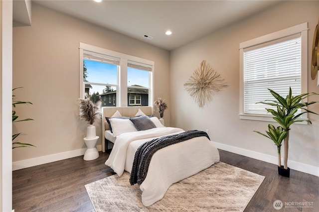 bedroom featuring wood finished floors, recessed lighting, baseboards, and visible vents