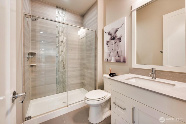 full bathroom featuring tile patterned floors, toilet, a stall shower, and vanity