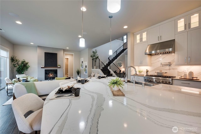 living area featuring stairway, recessed lighting, and a fireplace