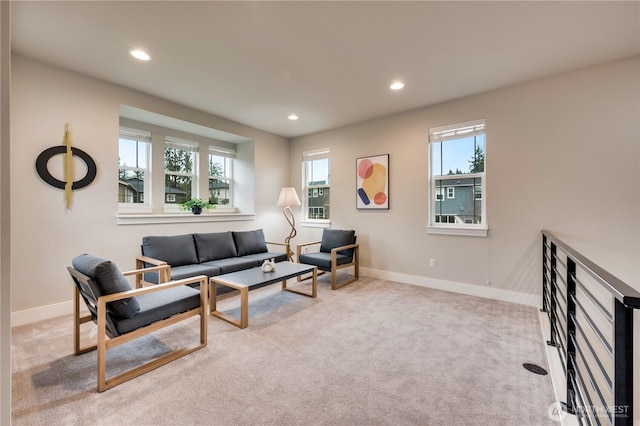 carpeted living area featuring recessed lighting and baseboards