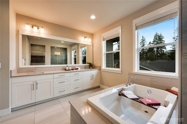 bathroom with tile patterned floors, a sink, a jetted tub, recessed lighting, and double vanity