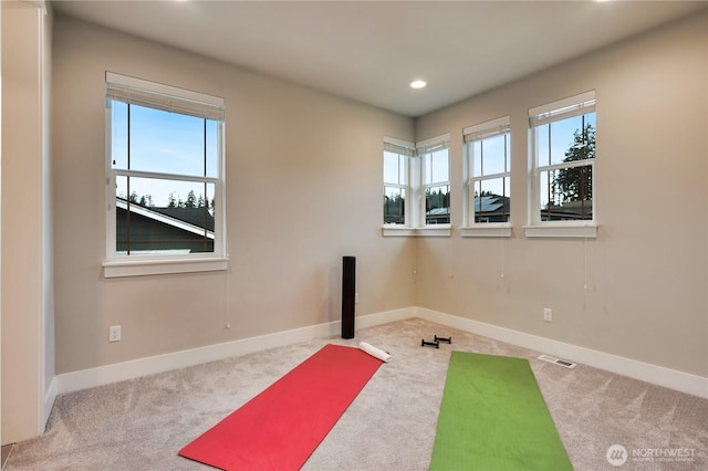 workout area featuring recessed lighting, baseboards, and carpet floors