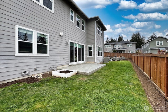 rear view of property featuring a patio area, a lawn, cooling unit, a fenced backyard, and crawl space