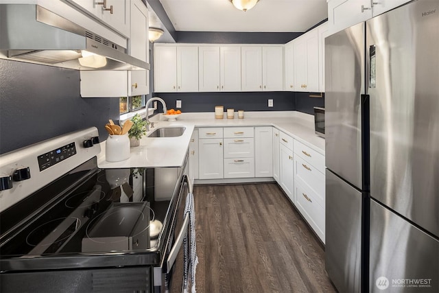 kitchen featuring a sink, under cabinet range hood, appliances with stainless steel finishes, white cabinetry, and dark wood-style flooring